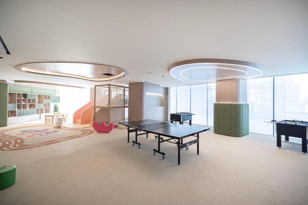 Games lounge with table tennis, foosball tables and a children's slide