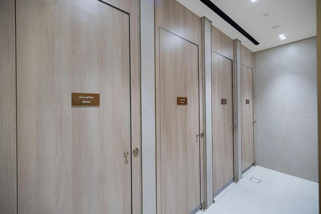 Spa shower cabins with timber doors and signage