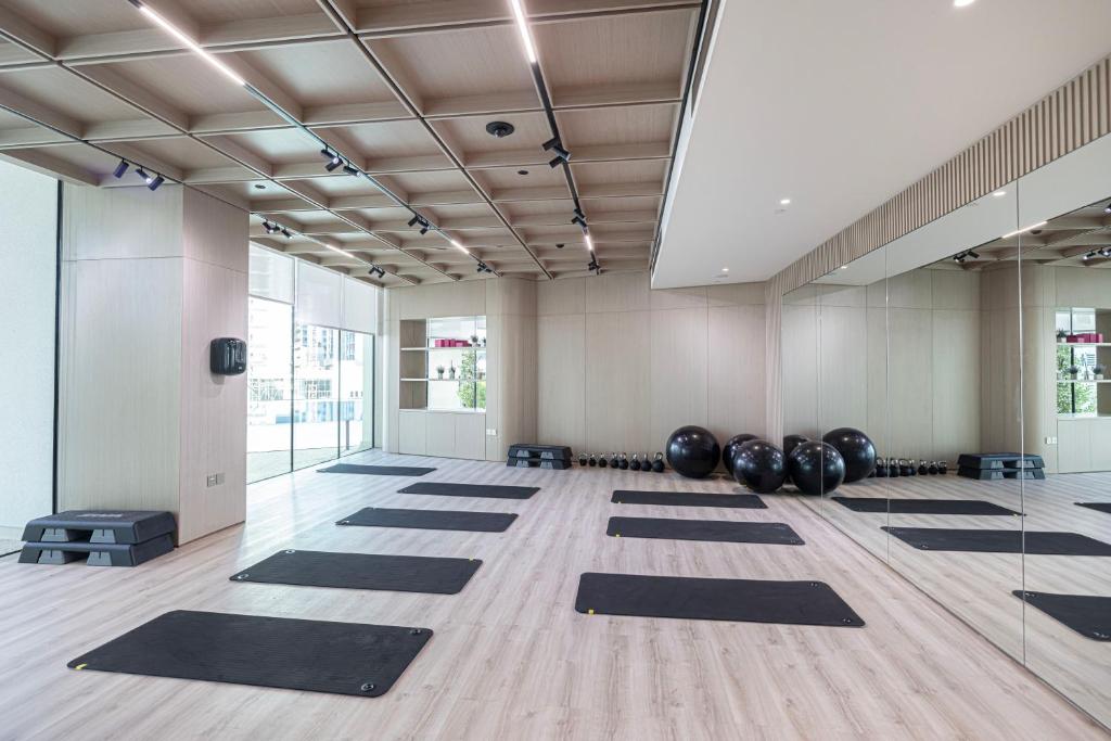 Mirrored yoga and stretching studio with mats and exercise balls